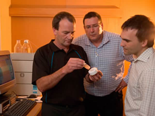Terry Smith, John Luxton and Nigel Slaughter looking at a sample of the novel polymers