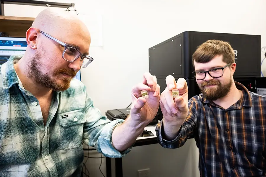Nate Davis and Jake Hardy holding prototype devices Nate Davis and Jake Hardy holding prototype devices
